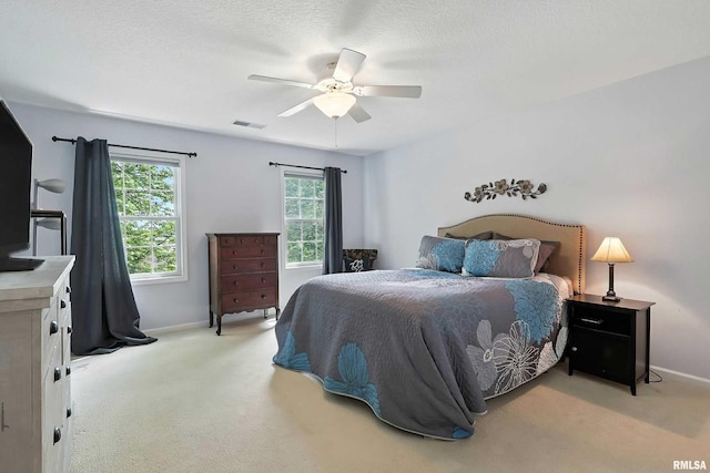 905 Bridgeview Place, Le Claire, IA 52753 - bedroom with light carpet, a ceiling fan, and a textured ceiling