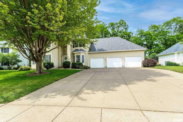905 Bridgeview Place, Le Claire, IA 52753 - view of front facade featuring driveway, a front yard, and a garage