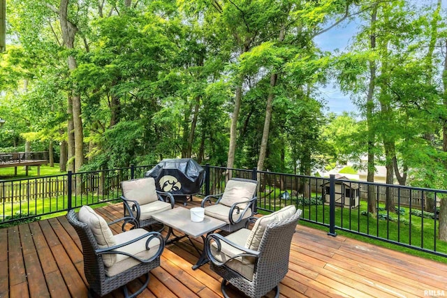 905 Bridgeview Place, Le Claire, IA 52753 - wooden deck featuring area for grilling, view of scattered trees, and a lawn