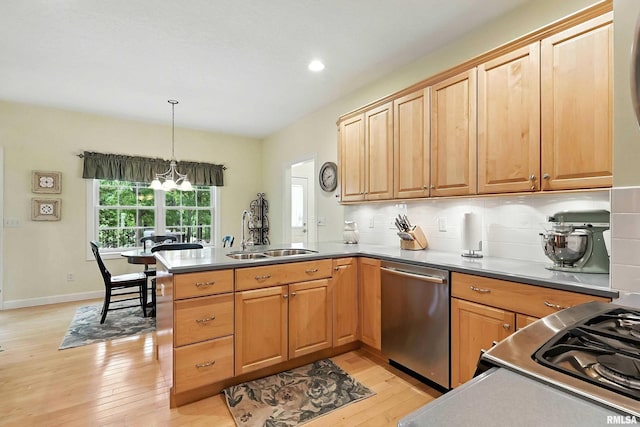 905 Bridgeview Place, Le Claire, IA 52753 - kitchen with stainless steel dishwasher, a peninsula, light wood finished floors, tasteful backsplash, and hanging light fixtures