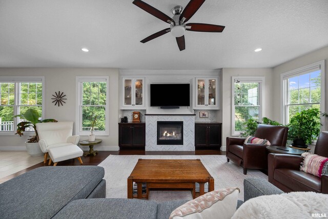 5727 Charlie Chase Ln, Bettendorf, IA 52722 - living area with a ceiling fan, a fireplace, and recessed lighting