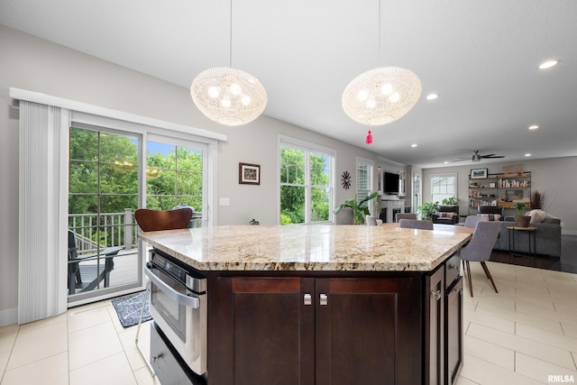 5727 Charlie Chase Ln, Bettendorf, IA 52722 - kitchen with a chandelier, stainless steel oven, healthy amount of natural light, dark brown cabinets, and recessed lighting