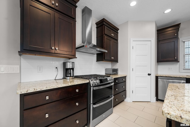 5727 Charlie Chase Ln, Bettendorf, IA 52722 - kitchen with wall chimney range hood, appliances with stainless steel finishes, tasteful backsplash, dark brown cabinetry, and light tile patterned floors
