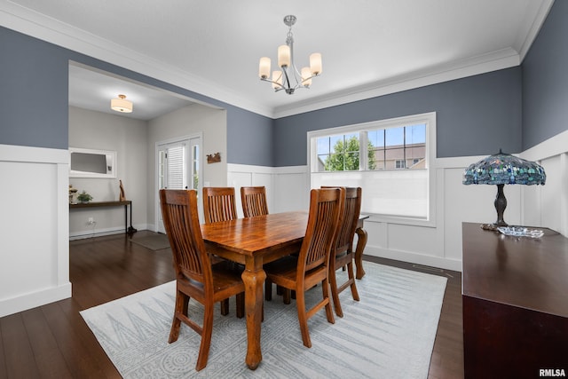 5727 Charlie Chase Ln, Bettendorf, IA 52722 - dining area featuring a chandelier, wainscoting, wood finished floors, ornamental molding, and a baseboard radiator