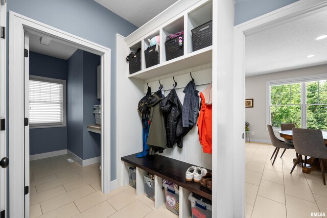 5727 Charlie Chase Ln, Bettendorf, IA 52722 - mudroom with tile patterned flooring, a textured ceiling, and recessed lighting