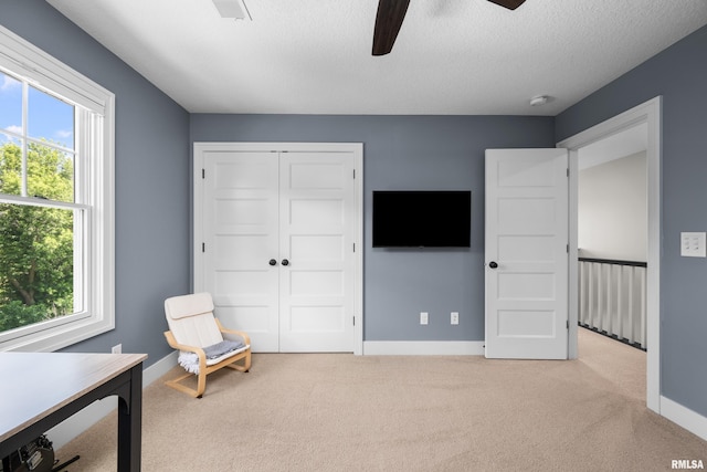 5727 Charlie Chase Ln, Bettendorf, IA 52722 - sitting room featuring plenty of natural light, a ceiling fan, carpet floors, and a textured ceiling
