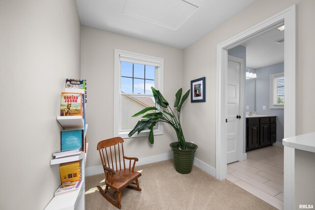 5727 Charlie Chase Ln, Bettendorf, IA 52722 - sitting room with baseboards and attic access