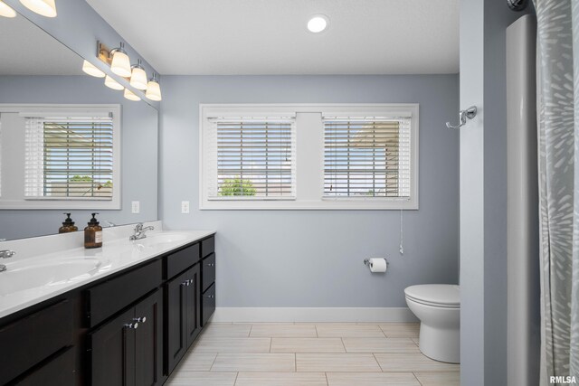 5727 Charlie Chase Ln, Bettendorf, IA 52722 - full bathroom with double vanity and baseboards