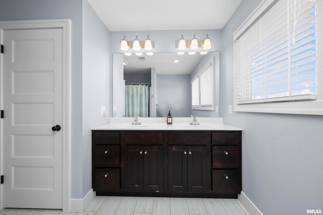 5727 Charlie Chase Ln, Bettendorf, IA 52722 - full bath featuring baseboards and double vanity