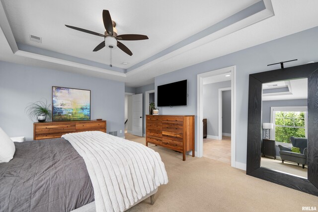 5727 Charlie Chase Ln, Bettendorf, IA 52722 - bedroom with a tray ceiling, light colored carpet, and ceiling fan