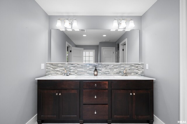 5727 Charlie Chase Ln, Bettendorf, IA 52722 - bathroom with double vanity and decorative backsplash