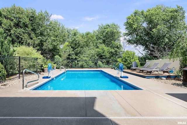 5727 Charlie Chase Ln, Bettendorf, IA 52722 - view of pool with a patio area and view of scattered trees