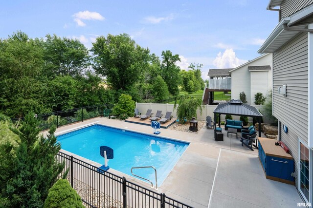 5727 Charlie Chase Ln, Bettendorf, IA 52722 - view of swimming pool featuring an outdoor living space, a gazebo, and a patio area