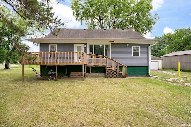 183 Island Ave, East Moline, IL 61244 - back of property featuring a wooden deck, a yard, roof with shingles, and an outdoor structure