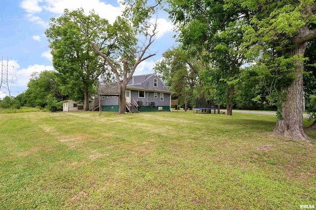 183 Island Ave, East Moline, IL 61244 - view of green lawn featuring a trampoline, stairs, a shed, and a wooden deck