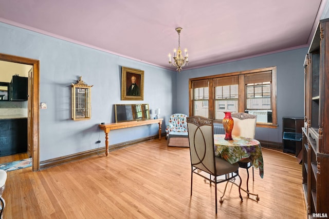1632 18th Ave Unit 6, Rock Island, IL 61201 - dining space featuring a chandelier, ornamental molding, and light wood-type flooring