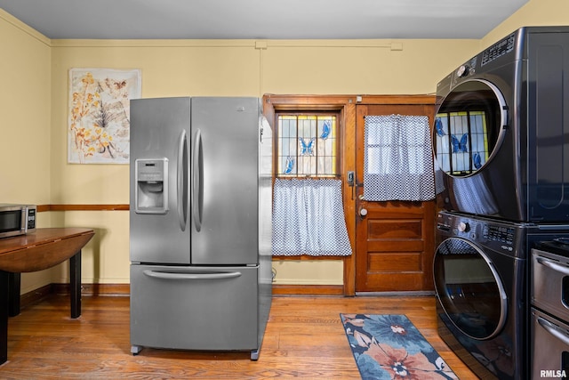 1632 18th Ave Unit 6, Rock Island, IL 61201 - kitchen with stainless steel appliances, stacked washer and clothes dryer, and wood finished floors