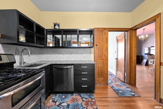 1632 18th Ave Unit 6, Rock Island, IL 61201 - kitchen featuring double oven range, dark cabinets, dishwasher, light wood finished floors, and decorative backsplash
