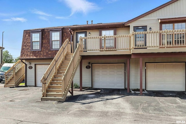 4011 Lillie Ave Unit 106, Davenport, IA 52806 - townhome / multi-family property featuring stairs, an attached garage, and a shingled roof