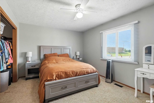 4011 Lillie Ave Unit 106, Davenport, IA 52806 - bedroom featuring light colored carpet, a textured ceiling, a closet, and a ceiling fan