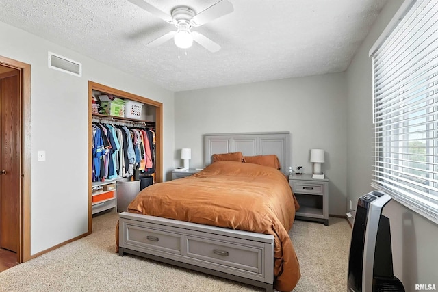 4011 Lillie Ave Unit 106, Davenport, IA 52806 - bedroom featuring light colored carpet, a closet, a textured ceiling, and ceiling fan