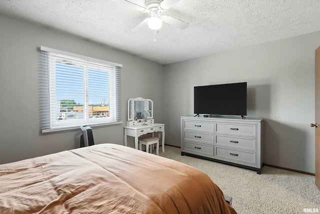 4011 Lillie Ave Unit 106, Davenport, IA 52806 - bedroom with light colored carpet, a textured ceiling, and a ceiling fan