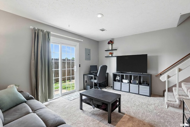 4011 Lillie Ave Unit 106, Davenport, IA 52806 - living area featuring carpet floors, stairs, electric panel, a desk, and a textured ceiling