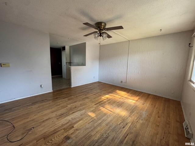 2938 Summit Hills Ct, Bettendorf, IA 52722 - unfurnished room with a ceiling fan, wood finished floors, and a textured ceiling