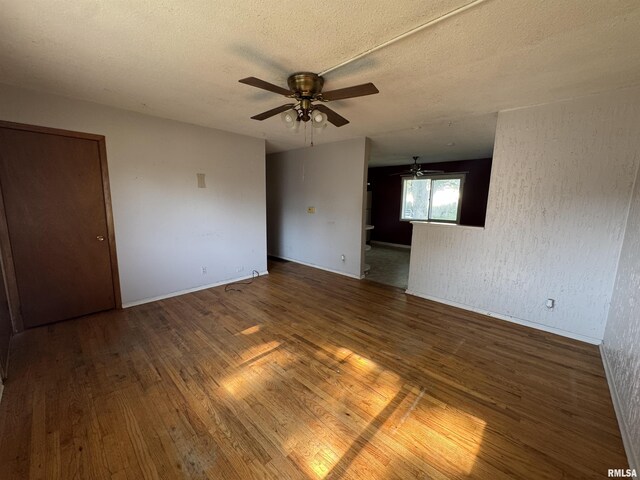 2938 Summit Hills Ct, Bettendorf, IA 52722 - spare room featuring wood finished floors, ceiling fan, and a textured ceiling