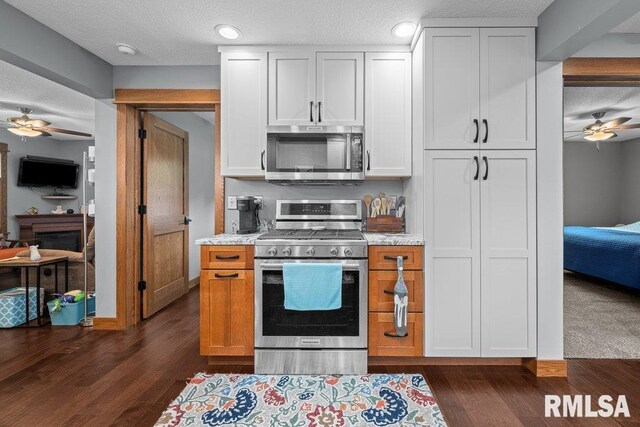 11815 Rte 84 N, Port Byron, IL 61275 - kitchen featuring appliances with stainless steel finishes, a ceiling fan, dark wood-style flooring, white cabinets, and a textured ceiling