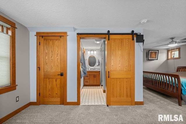 11815 Rte 84 N, Port Byron, IL 61275 - laundry room featuring a textured ceiling, a barn door, a ceiling fan, and carpet