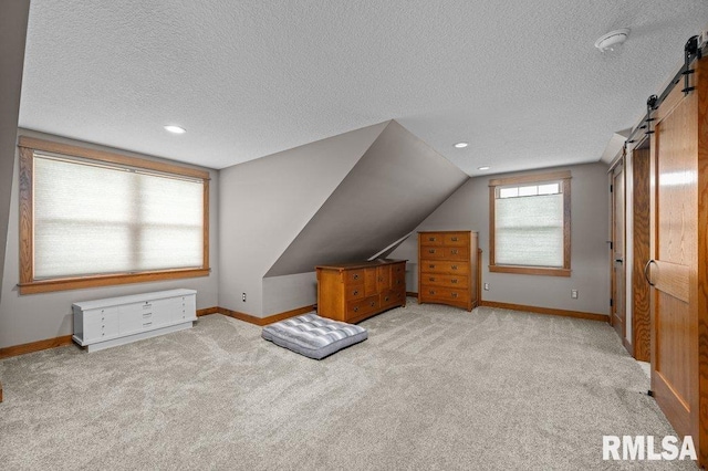 11815 Rte 84 N, Port Byron, IL 61275 - additional living space with a barn door, a textured ceiling, carpet floors, lofted ceiling, and recessed lighting