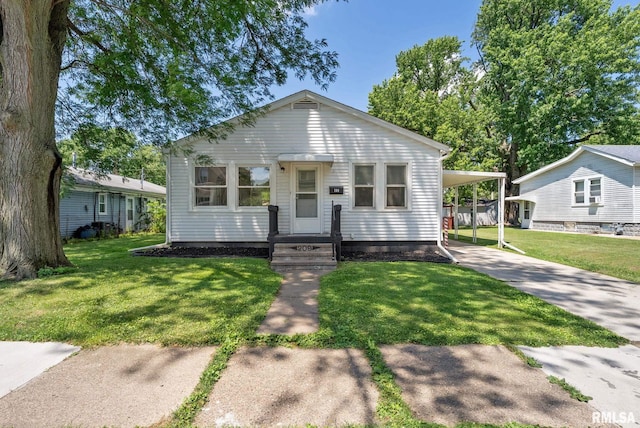 209 45th St, Moline, IL 61265 - view of front of property featuring driveway, a front lawn, and an attached carport