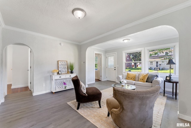 209 45th St, Moline, IL 61265 - living room with arched walkways, wood finished floors, crown molding, and a textured ceiling