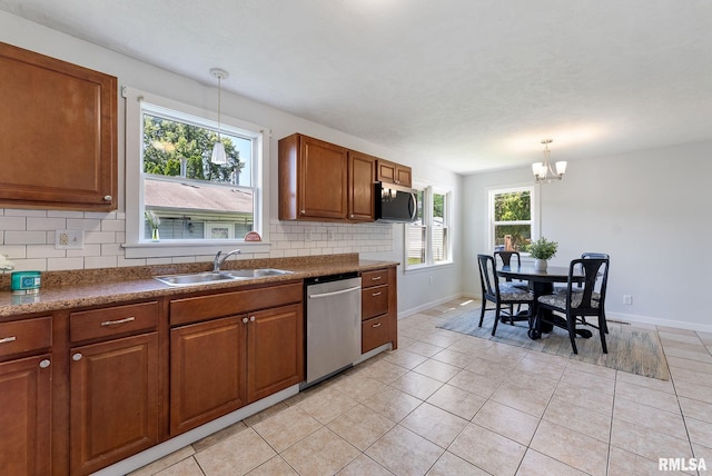 209 45th St, Moline, IL 61265 - kitchen with stainless steel appliances, tasteful backsplash, brown cabinets, a chandelier, and light tile patterned floors