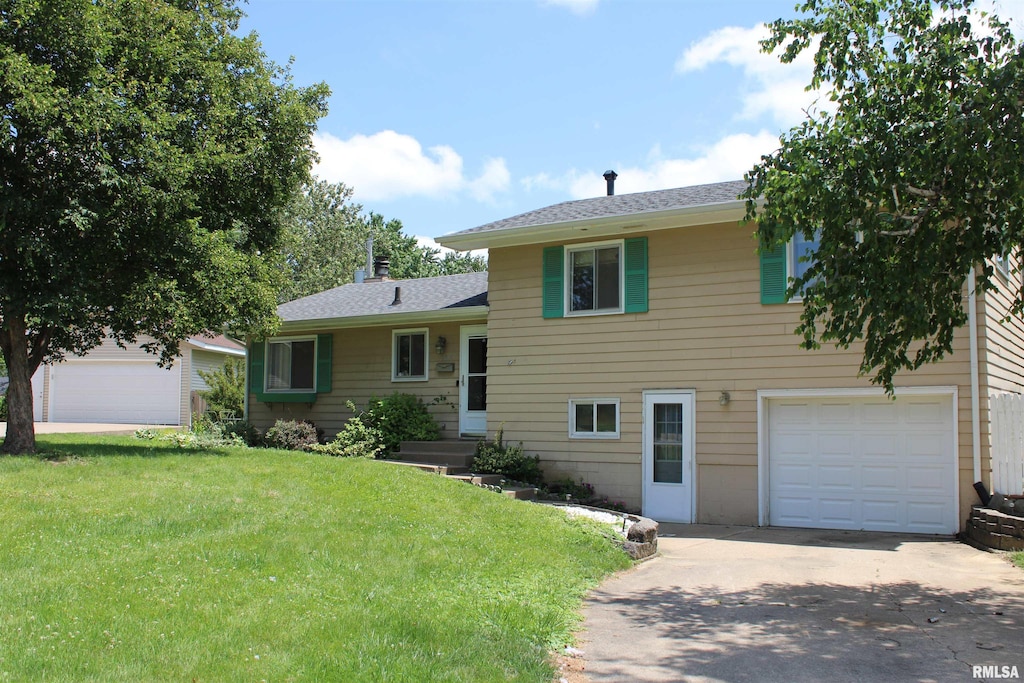 2809 Hillside Ct, Bettendorf, IA 52722 - tri-level home featuring an attached garage, a front yard, concrete driveway, and a shingled roof