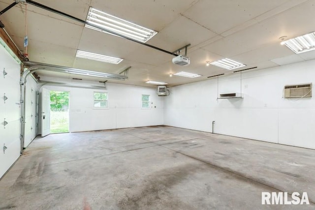1231 Devils Glen Rd, Bettendorf, IA 52722 - garage featuring an AC wall unit and a garage door opener