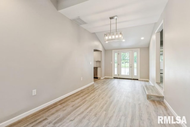 1231 Devils Glen Rd, Bettendorf, IA 52722 - unfurnished living room featuring light wood finished floors and lofted ceiling