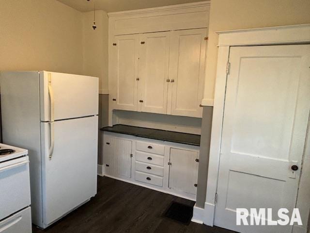 712 Roosevelt Ave, Kewanee, IL 61443 - kitchen featuring white appliances, white cabinetry, dark wood-style flooring, and dark countertops