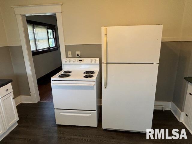 712 Roosevelt Ave, Kewanee, IL 61443 - kitchen featuring white appliances, white cabinetry, dark wood-type flooring, and dark countertops