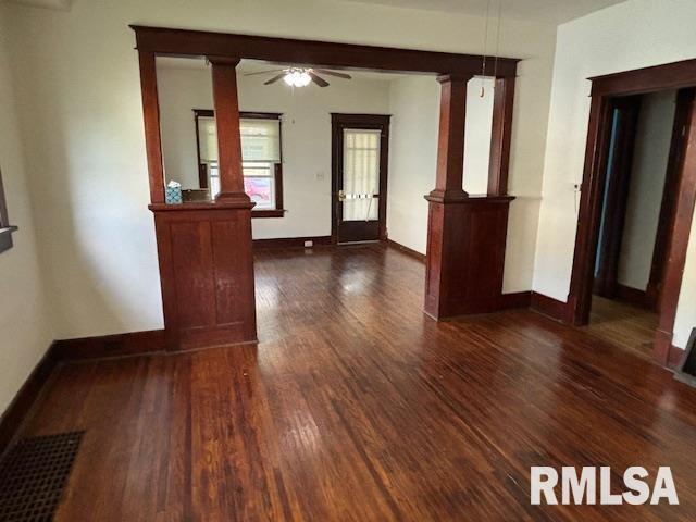 712 Roosevelt Ave, Kewanee, IL 61443 - foyer entrance with dark wood-style flooring, ornate columns, and a ceiling fan