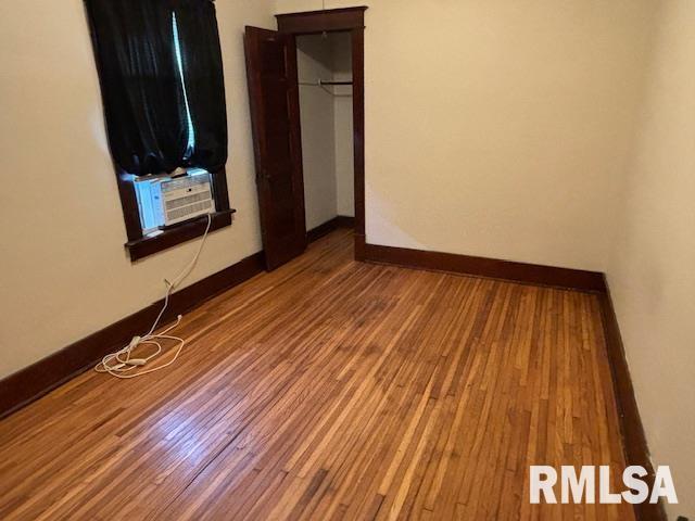 712 Roosevelt Ave, Kewanee, IL 61443 - unfurnished bedroom with wood finished floors and cooling unit