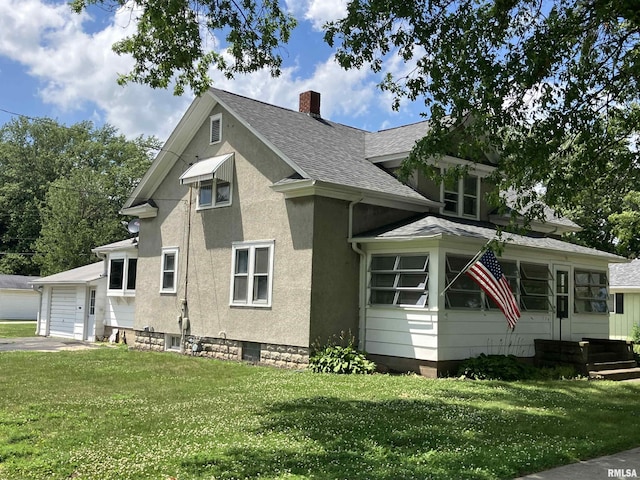 114 S State St, Annawan, IL 61234 - view of front of house with a shingled roof, a front yard, a chimney, and a garage