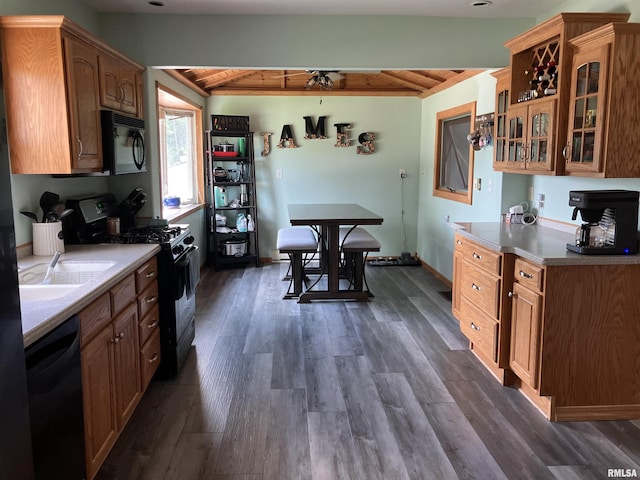 114 S State St, Annawan, IL 61234 - kitchen with black appliances, a wood ceiling with exposed beams, dark wood-type flooring, glass insert cabinets, and light countertops