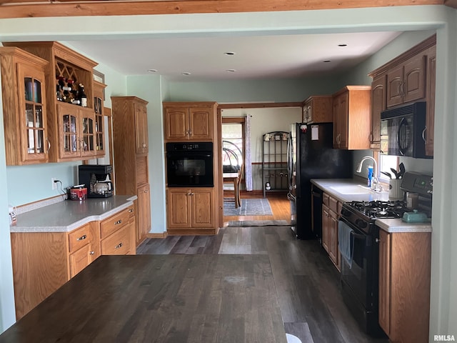 114 S State St, Annawan, IL 61234 - kitchen with black appliances, dark wood-style floors, glass insert cabinets, light countertops, and recessed lighting