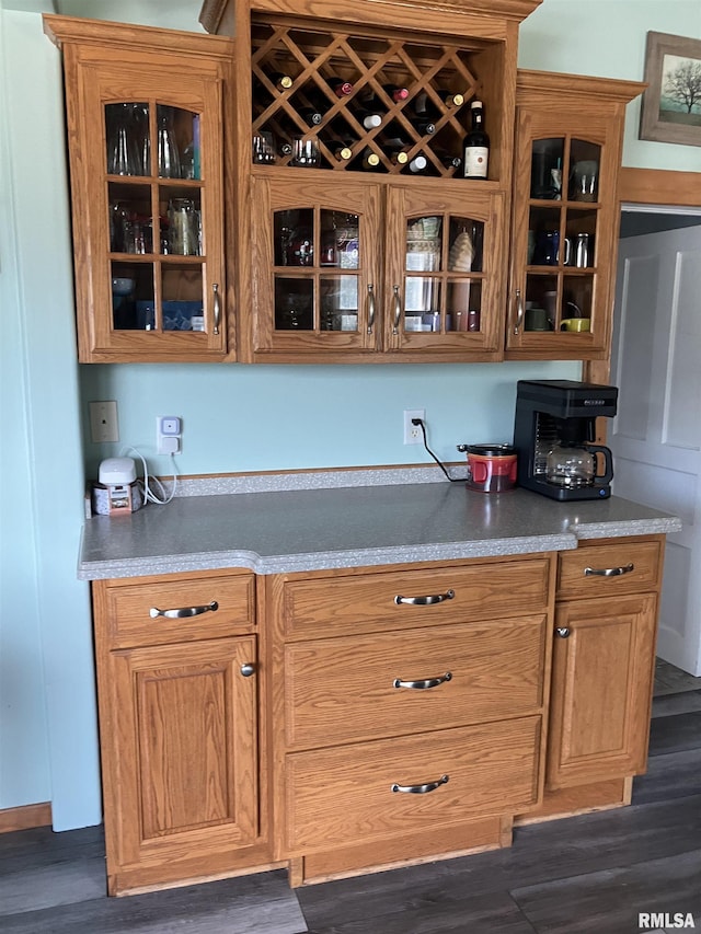 114 S State St, Annawan, IL 61234 - kitchen featuring glass insert cabinets, dark wood finished floors, brown cabinets, and light countertops