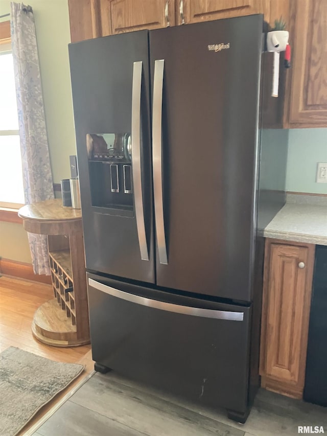 114 S State St, Annawan, IL 61234 - kitchen view of fridge with ice dispenser, light wood-type flooring, and brown cabinetry