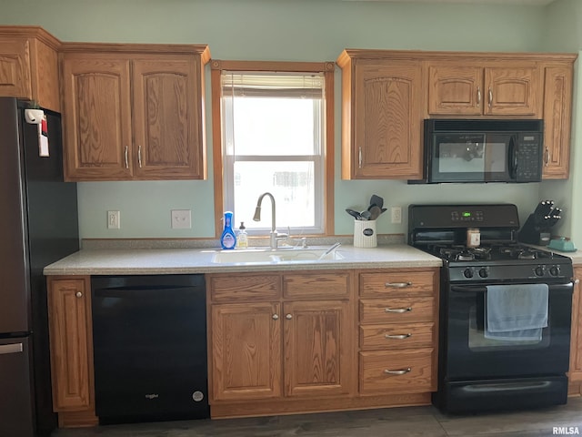 114 S State St, Annawan, IL 61234 - kitchen featuring black appliances, light countertops, and brown cabinetry