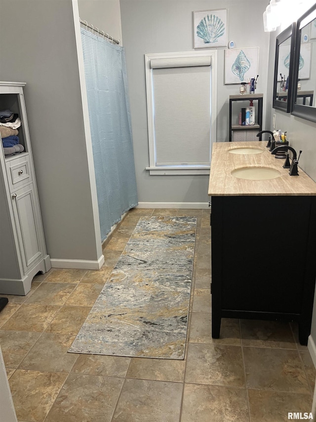 114 S State St, Annawan, IL 61234 - bathroom with double vanity, stone finish flooring, and a shower with curtain