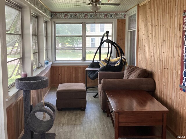 114 S State St, Annawan, IL 61234 - sunroom / solarium featuring wooden walls, ceiling fan, and wood finished floors